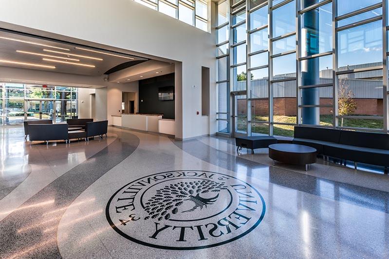 Frisch Welcome Center lobby featuring Jacksonville University logo inset in terrazzo floor